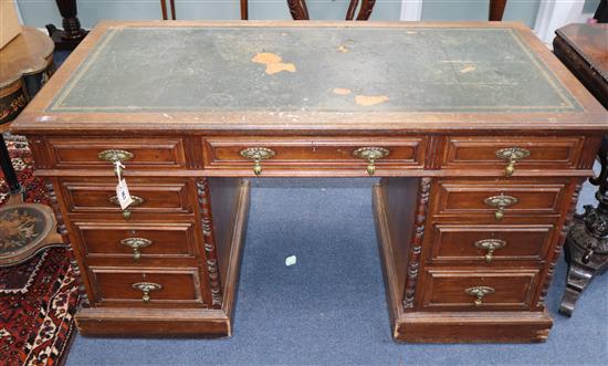 An Edwardian oak pedestal desk W.138cm